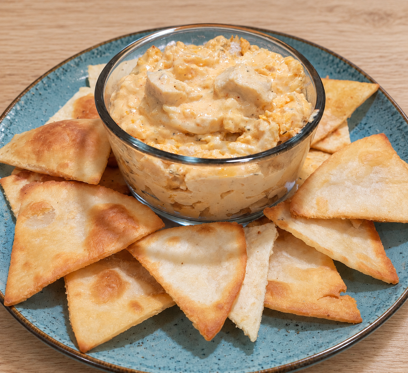Keto Buffalo chicken dip with shredded chicken and melted cheese, served warm as a creamy appetizer.