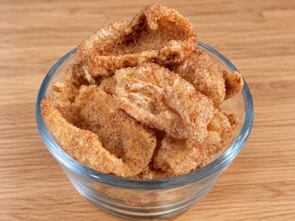 Keto cinnamon toast pork rinds coated in sweet cinnamon seasoning