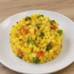 Yellow Mexican cauliflower rice with bell peppers and onion served in a bowl