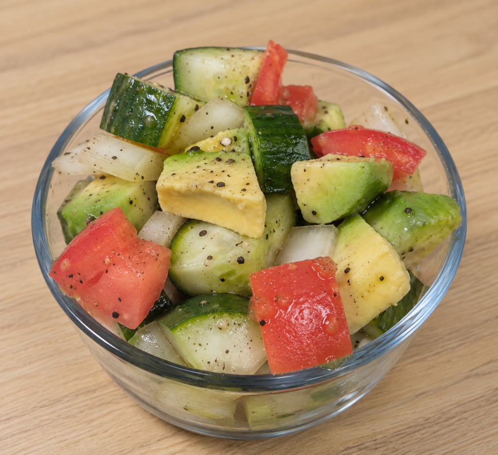 Cucumber, avocado and tomato salad with fresh vegetables and lemon-garlic dressing