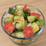Cucumber, avocado and tomato salad with fresh vegetables and lemon-garlic dressing